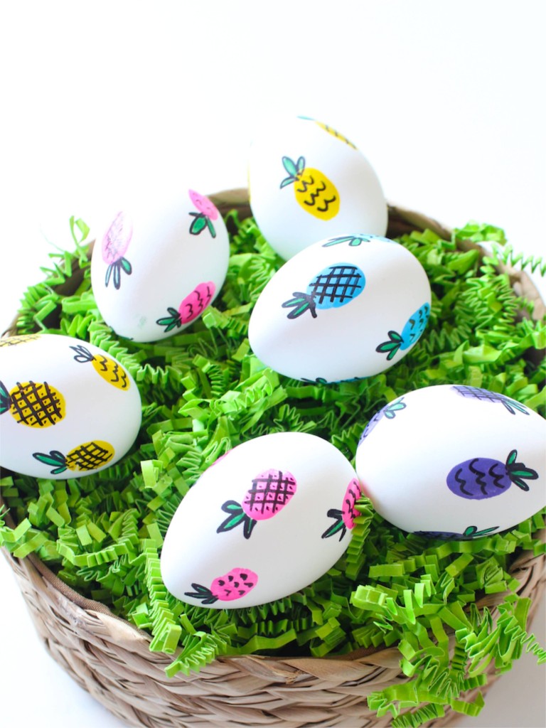 easter-eggs-in-a-basket-with-colorful-pineapples-and-green-grass