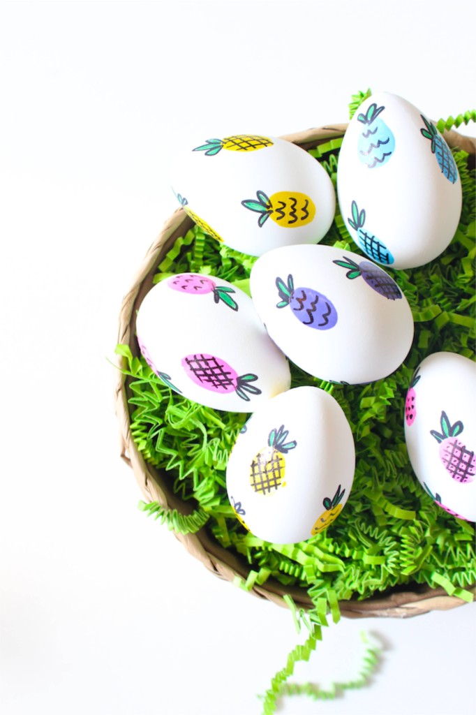 easter-eggs-in-a-basket-with-colorful-pineapples-and-green-grass