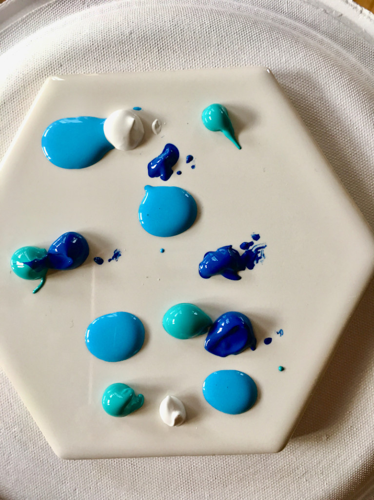 white tile with blue dabs of paint