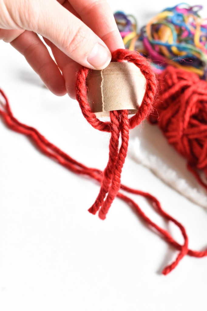 strips of red yarn for DIY beanie ornaments-yarn crafts for kids